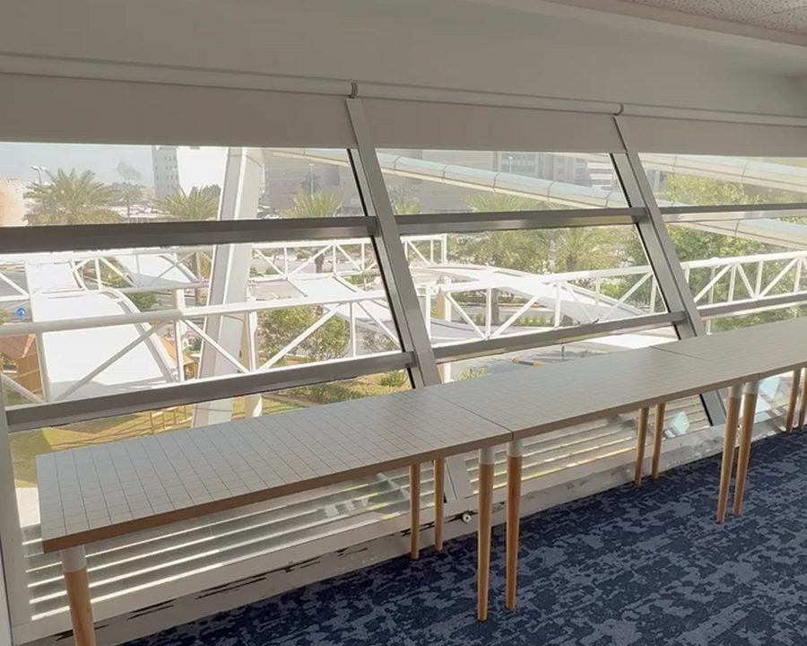 Roller blinds fitted to angled clerestory glazing in a conference room