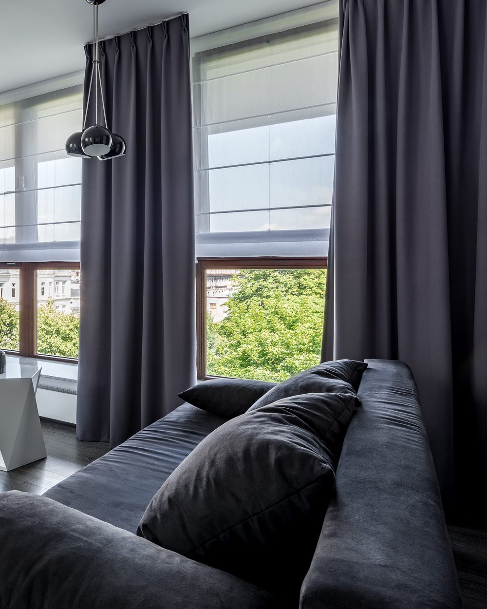 Full-height curtains and roman blinds in a contemporary living room