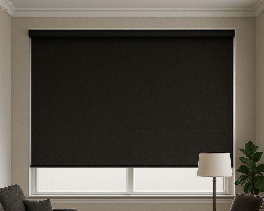 Blackout roller blind lowered over a living room window